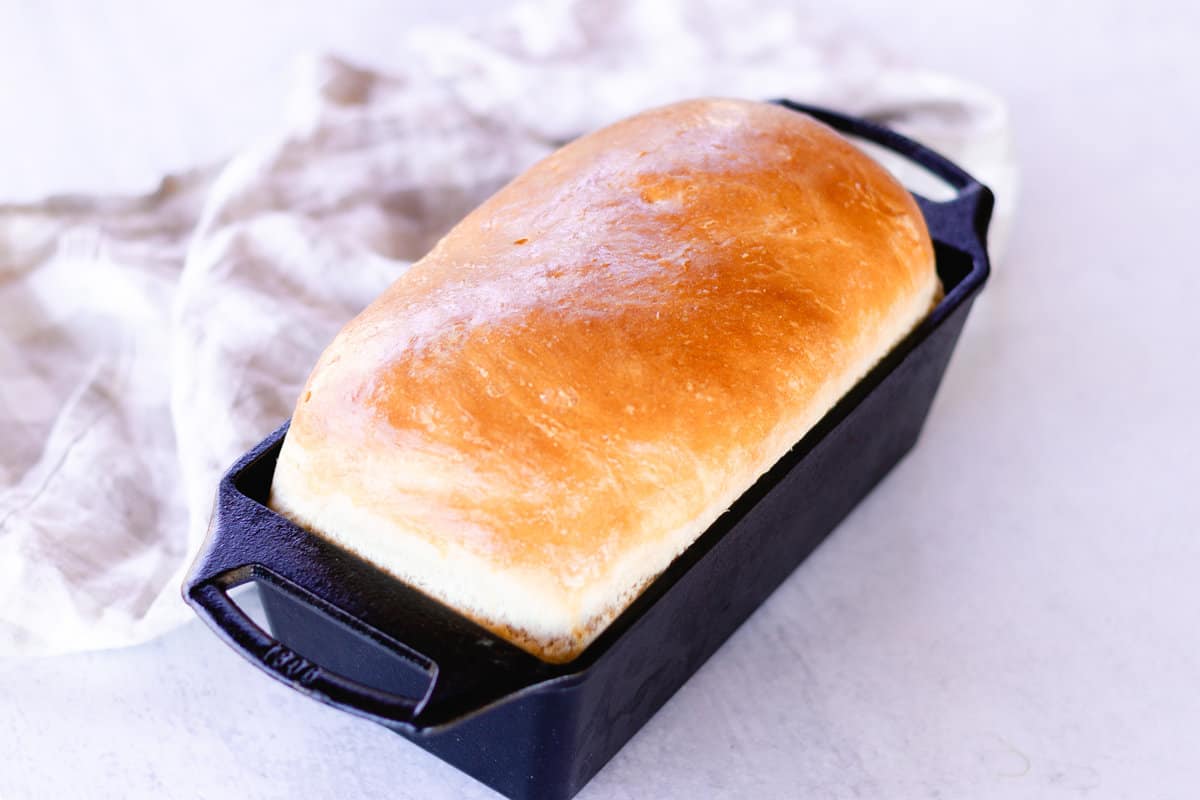 Fresh baked bread in a cast iron loaf bread pan.