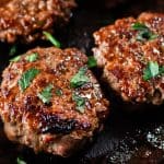 Searing moose sausage on a cast iron skillet.