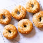 Onion Bagels cooling on a wire rack.