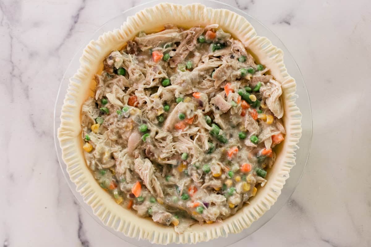 The filling for the chicken pot pie inside of the base layer.