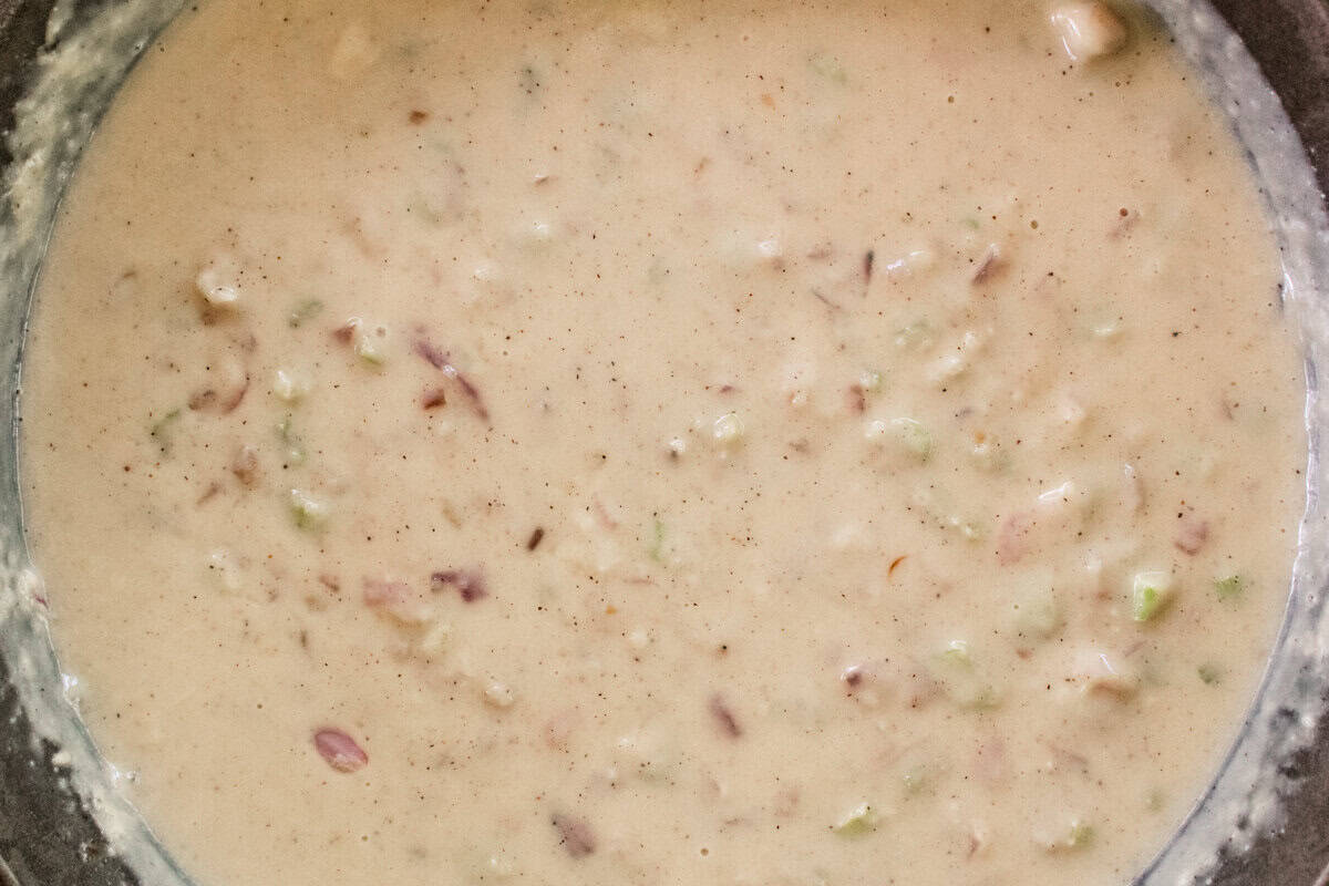 Bringing the gravy to simmer in the skillet.