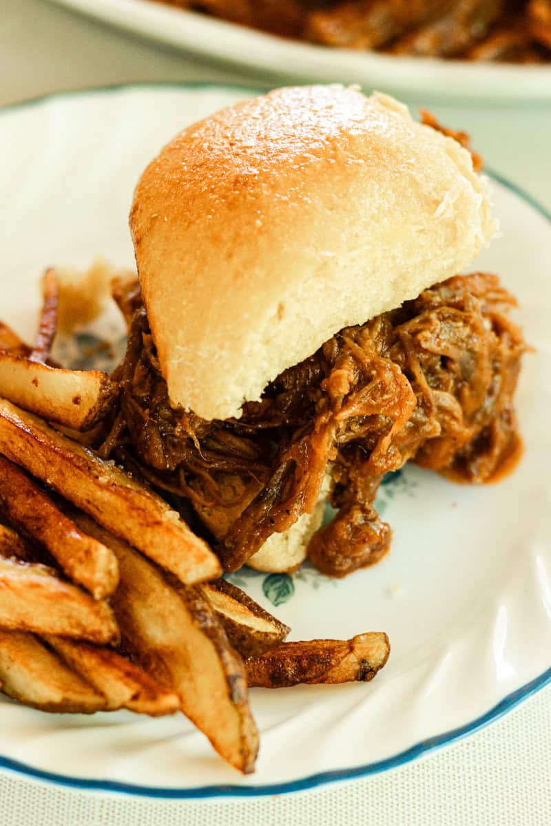 Pulled beef sandwich on a homemade roll with crispy french fries!