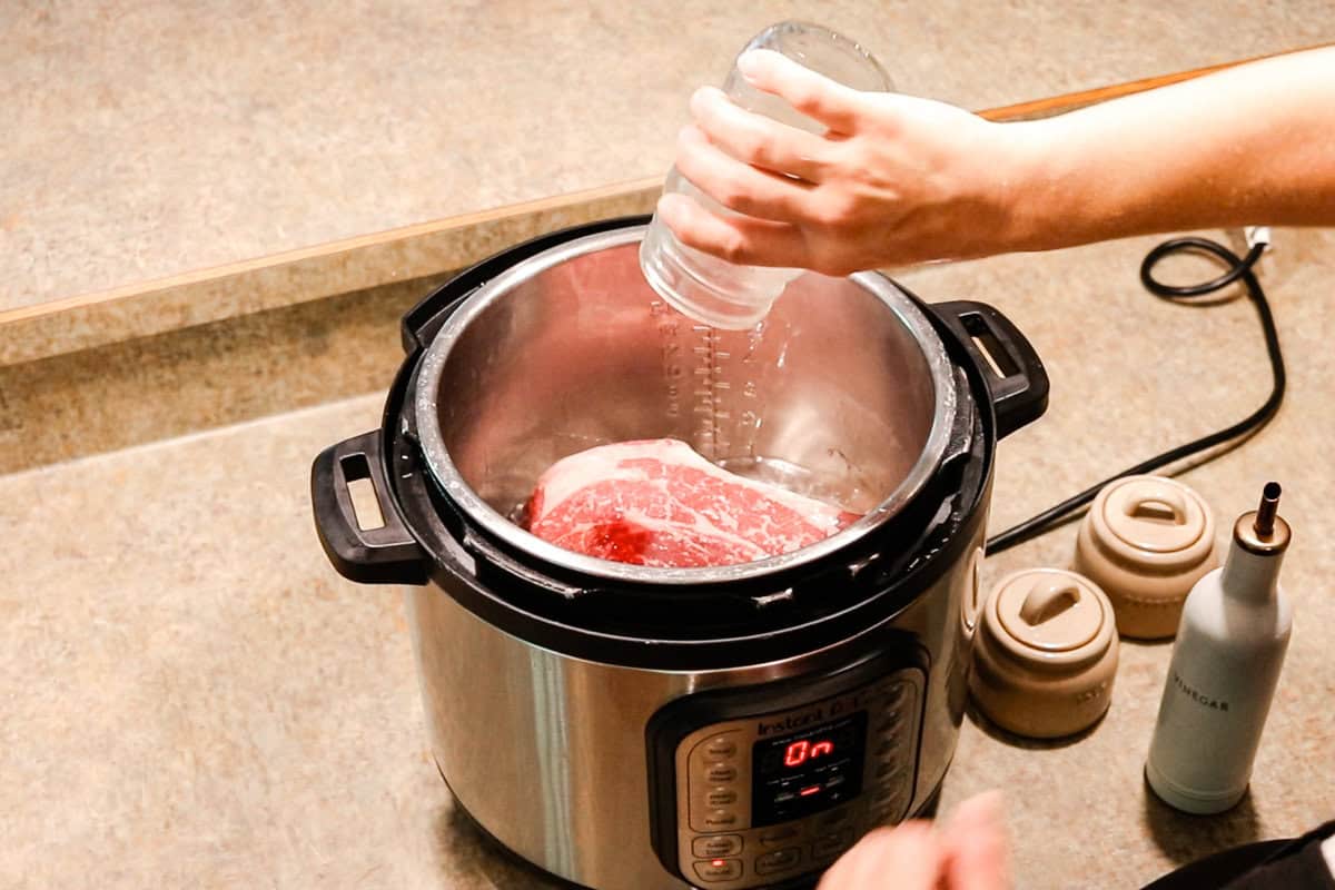 Adding the ingredients to the roast before cooking it.