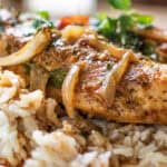 Thai Chicken curry with sauteed onions on a bed of white rice.