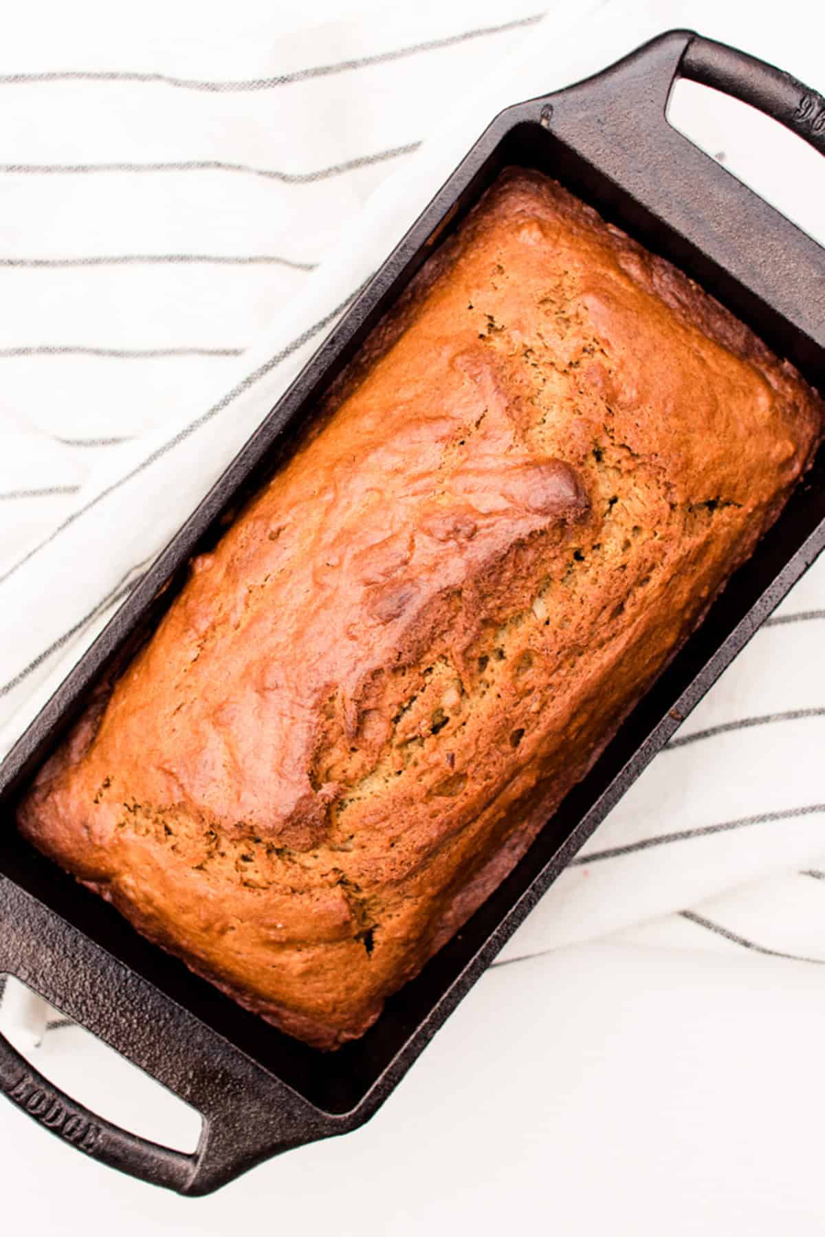 Chocolate chip banana bread fresh out of the oven still in the cast iron loaf pan. 