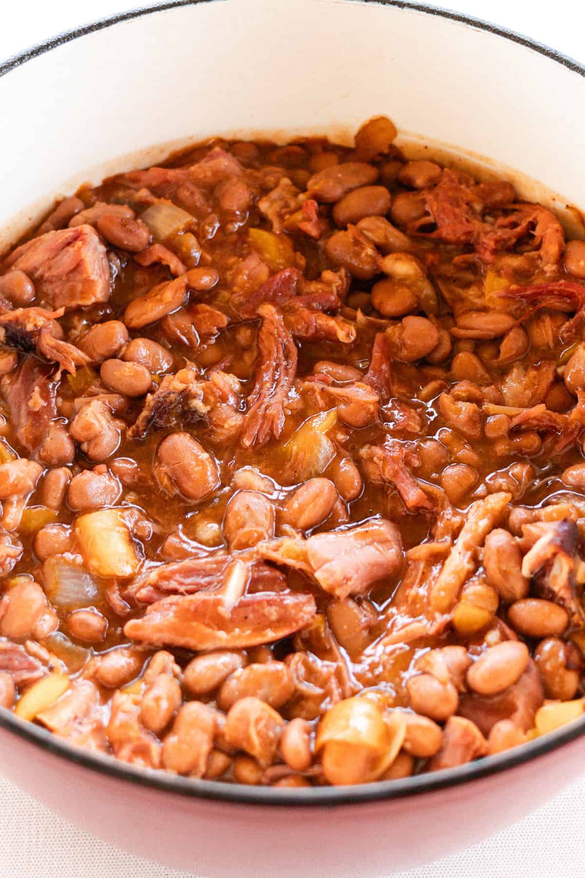 Dutch oven baked beans in a large dutch oven.