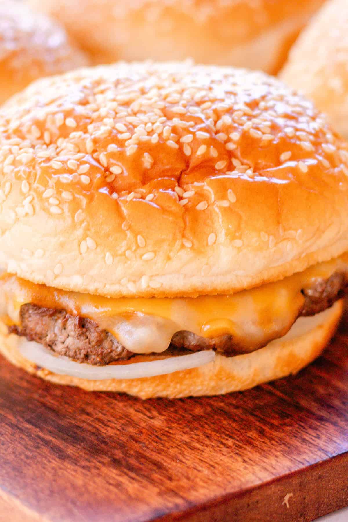 Homemade venison burger with melted cheese and onions.