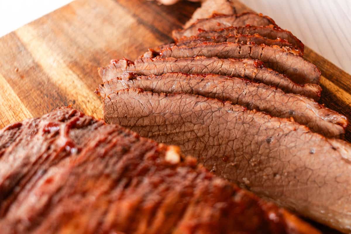 Sliced Beef Brisket on a wooden cutting board.