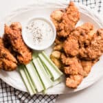 Homemade dutch oven fried chicken tenders with crispy breading, celery and homemade ranch.