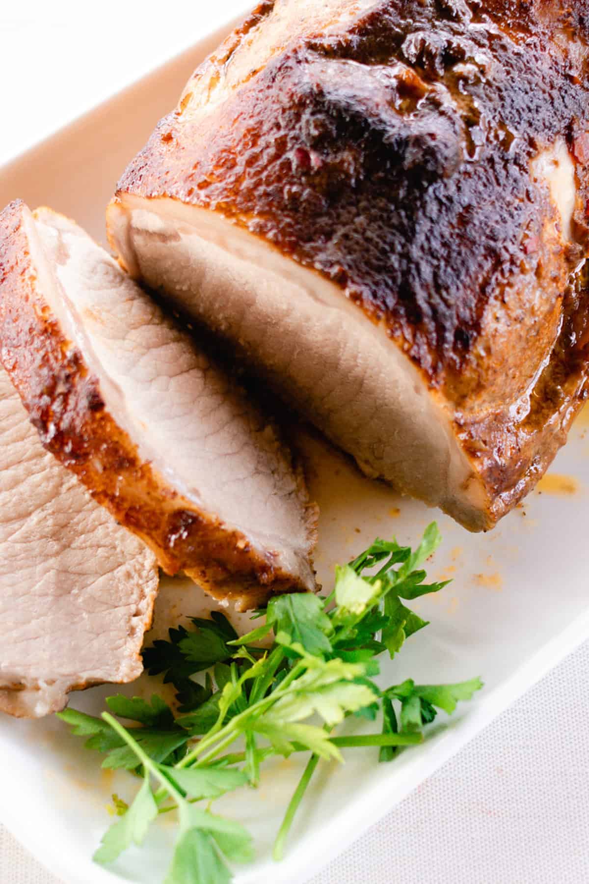 Thinly sliced pork loin with a crispy dry rub and savory glaze on top.