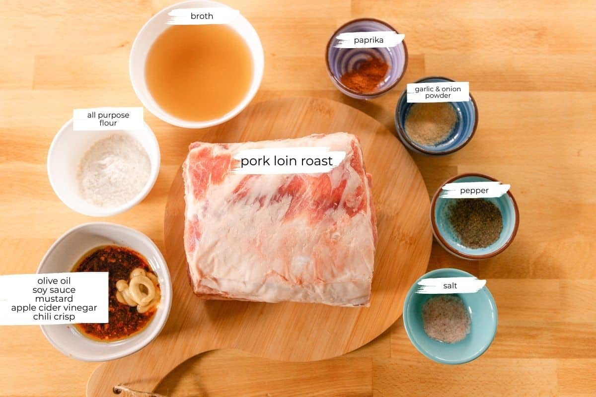 Pork loin roast ingredients measured out on a wooden table. 