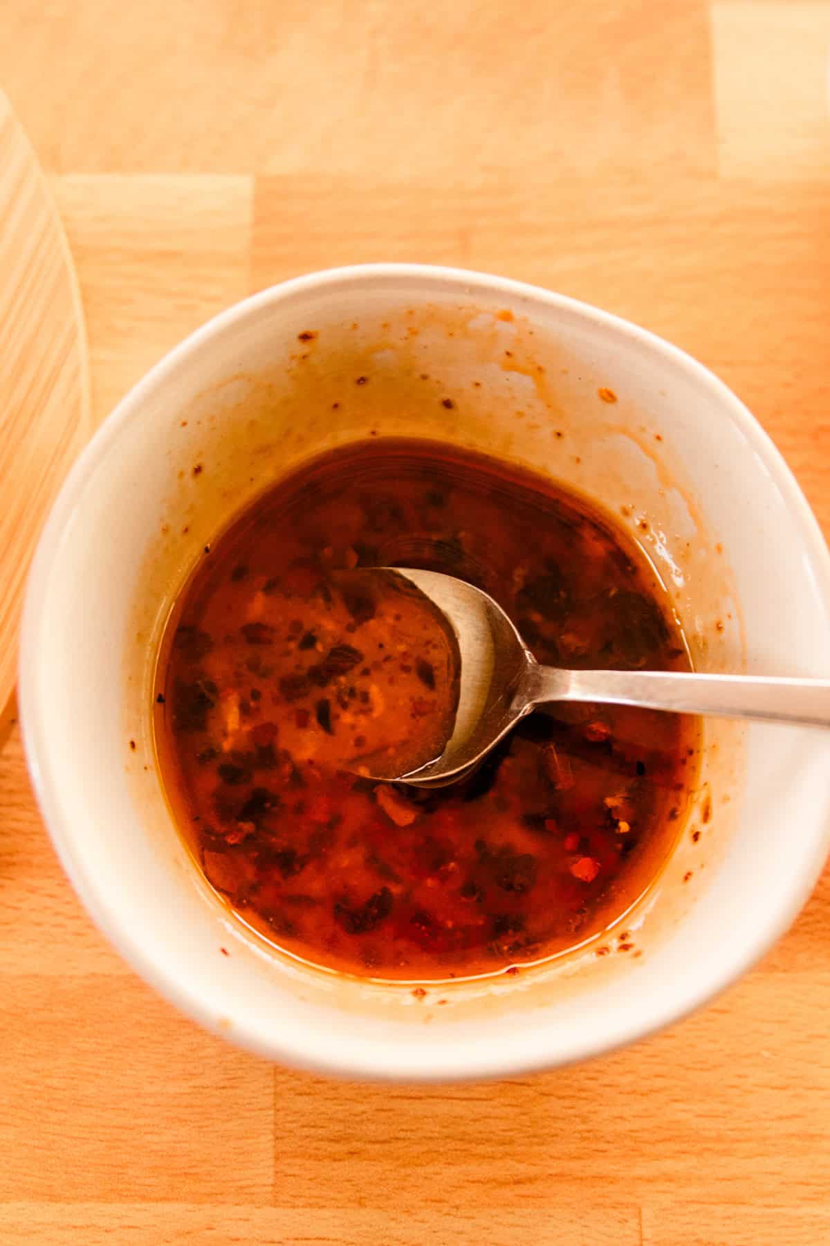 Combining the ingredients for the glaze in a small ramekin.