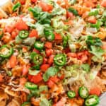 Pumpkin nachos with cheese and topped with fresh vegetables.