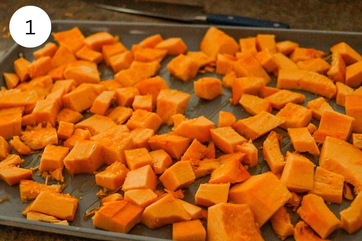 Roasting pumpkin on a baking sheet after drizzling it with olive oil.