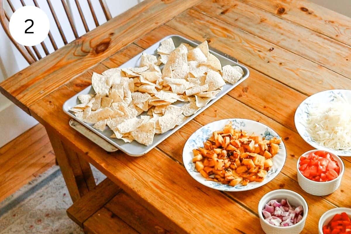Layering out the chips for the nachos on a baking sheet.