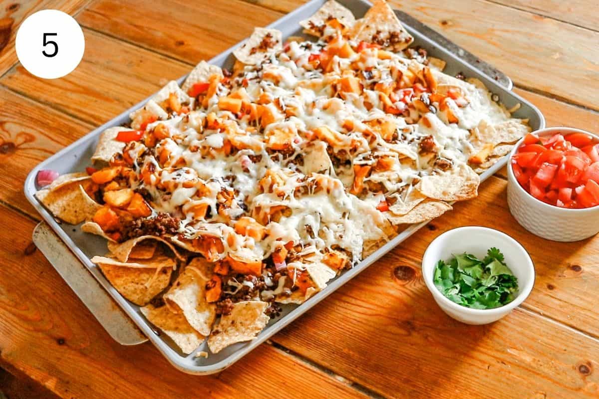 Pumpkin nachos after they have been baked with melted cheese oozing down the sides.