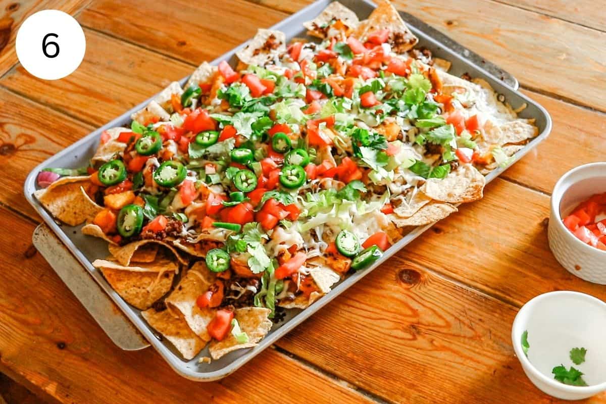 The nachos all garnished with fresh veggies, including lettuce, tomatoes and jalapeños.