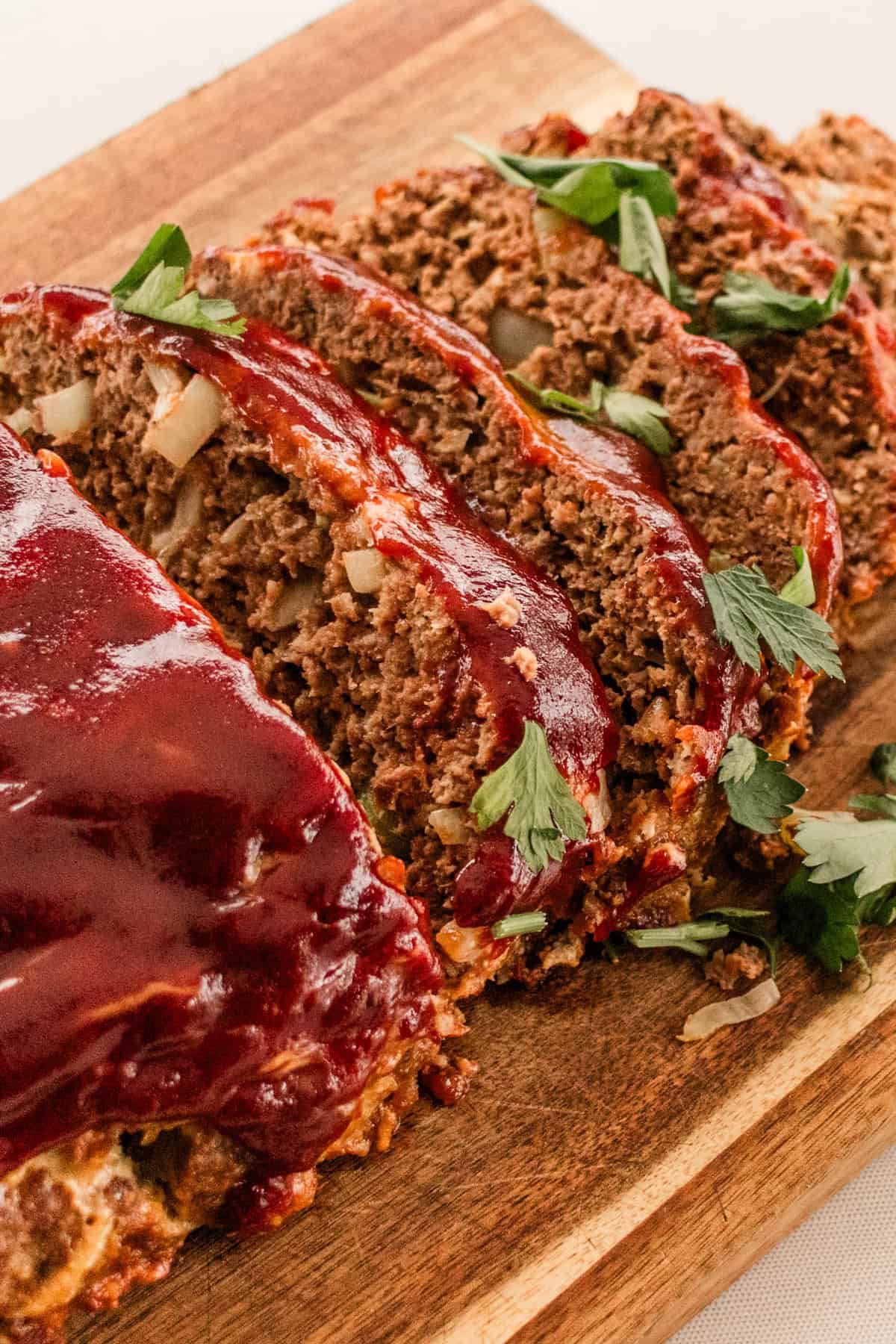 Sliced venison meatloaf with a sticky glaze on top.