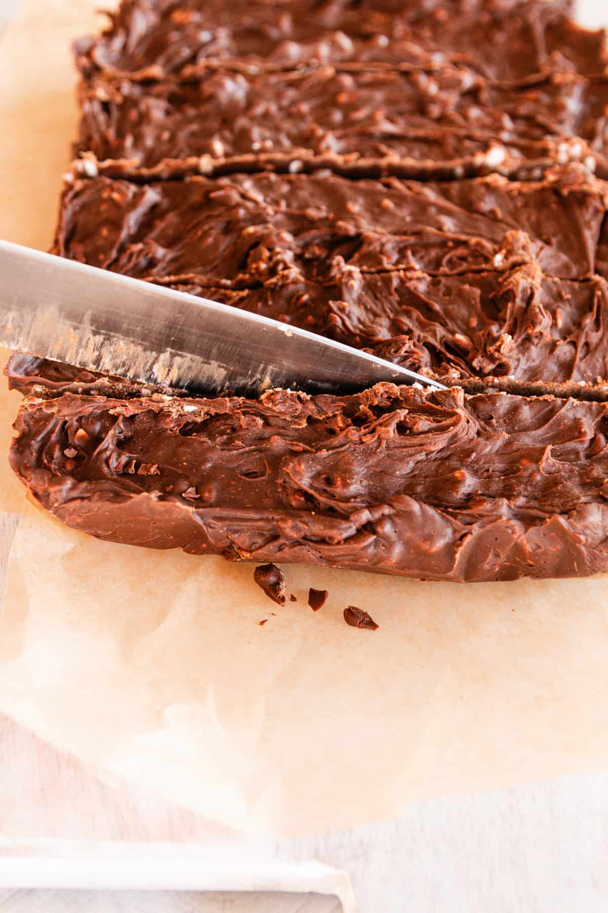 A knife cutting the fudge into even squares. 