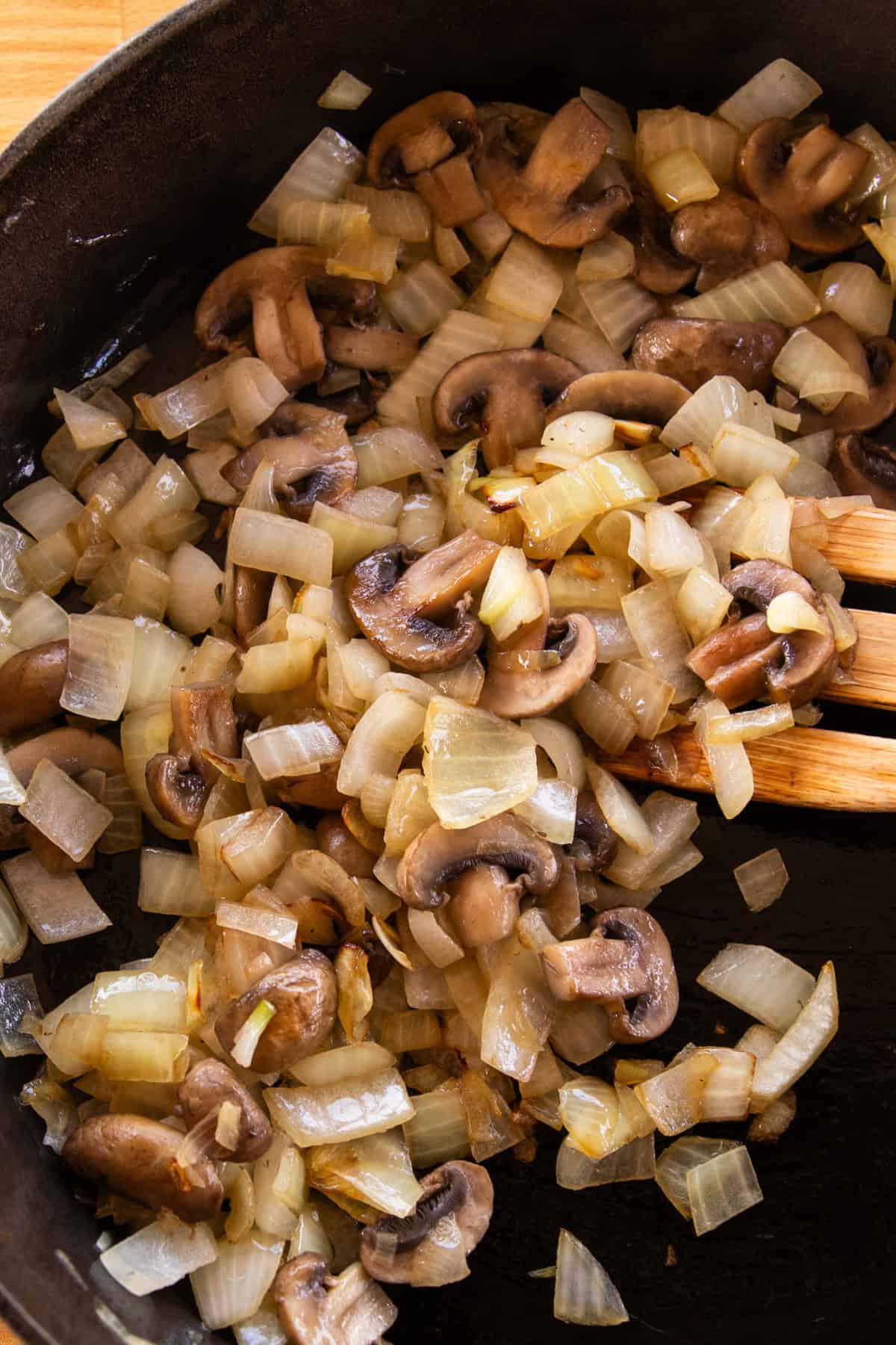 Sautéing onions and mushrooms in a cast iron skillet. 