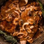 Round steak with gravy smothering it with sauteed onions and mushrooms.
