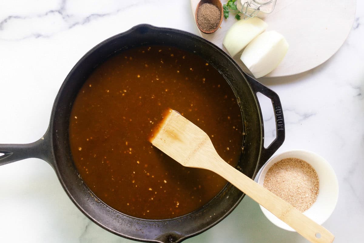 Stirring the gravy with a wooden spatula. 
