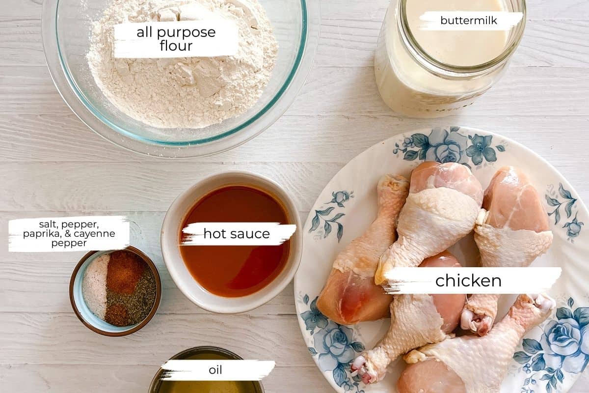 Ingredients needed for the fried chicken in individual bowls with text labels.
