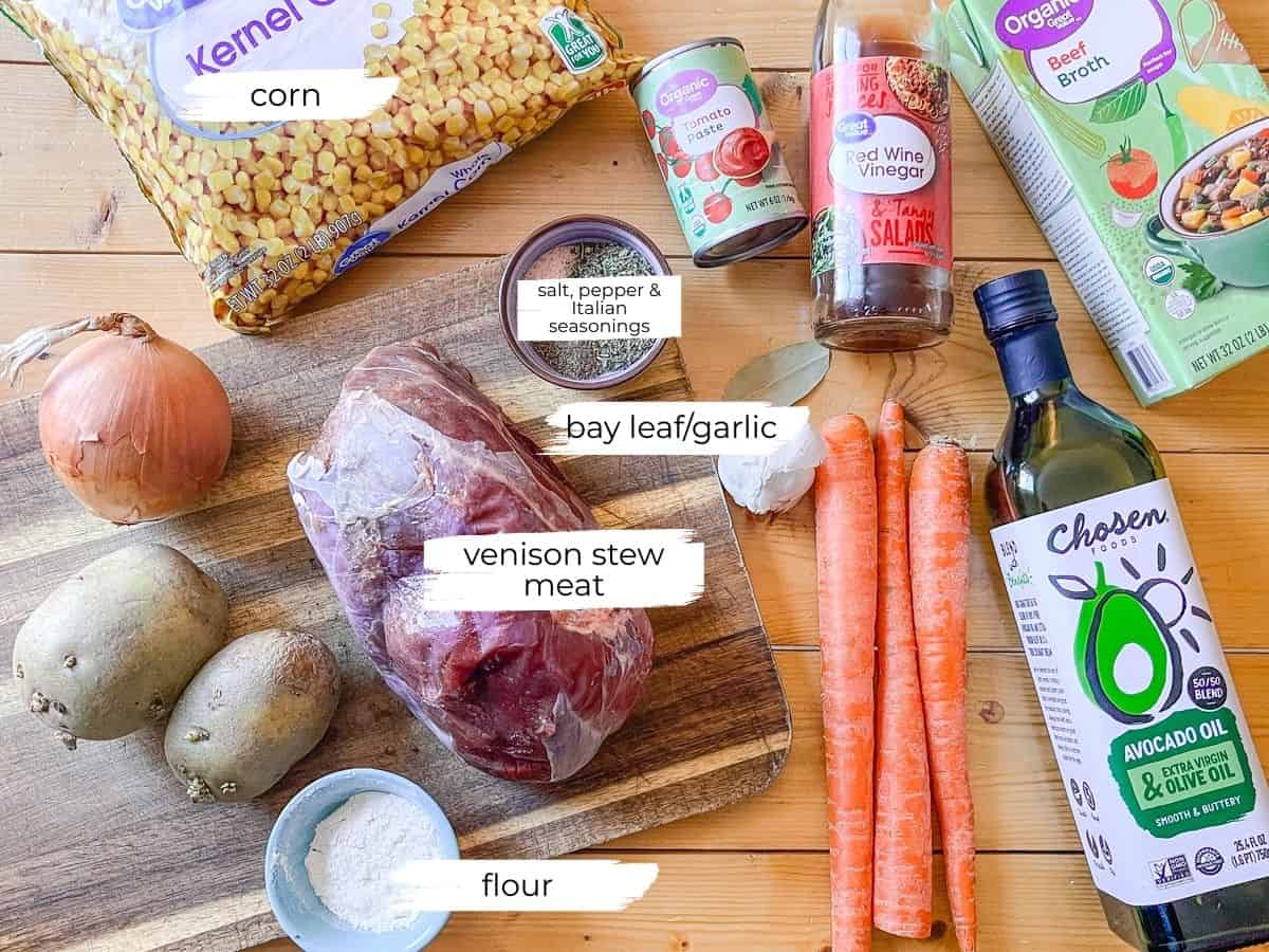 Dutch Oven Venison Stew ingredients laid out on a table with text labels.