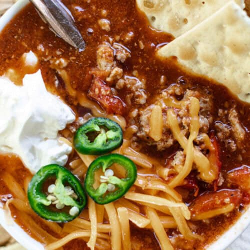 Ground Pork Chili served with crackers and sour cream on top.
