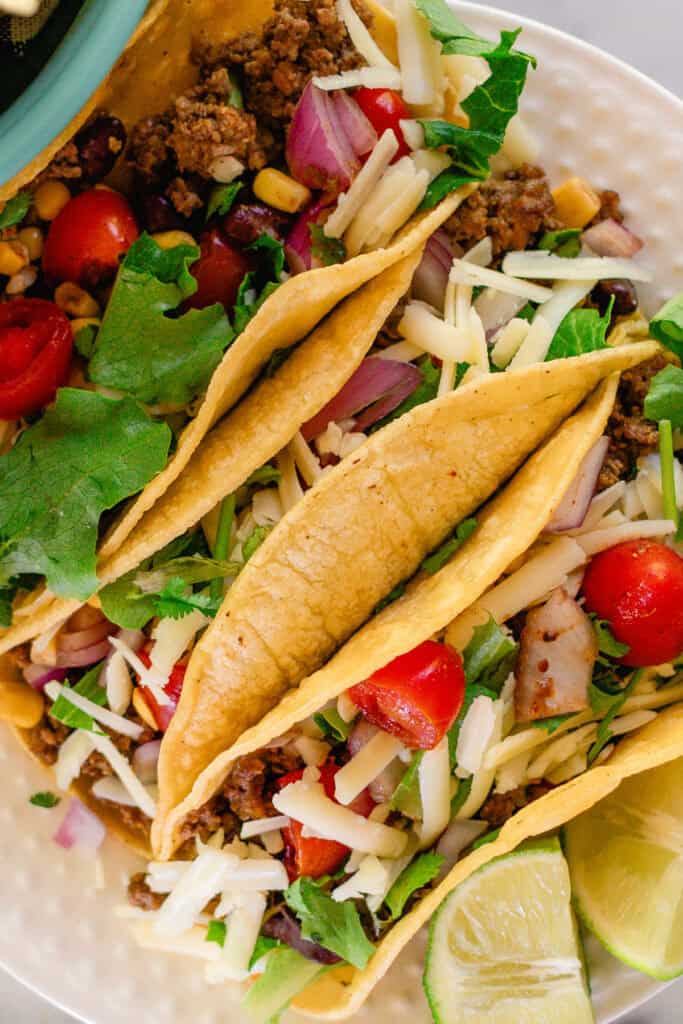 Three Venison Tacos on a white plate.