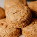 Whole grain biscuits stacked on a white plate.