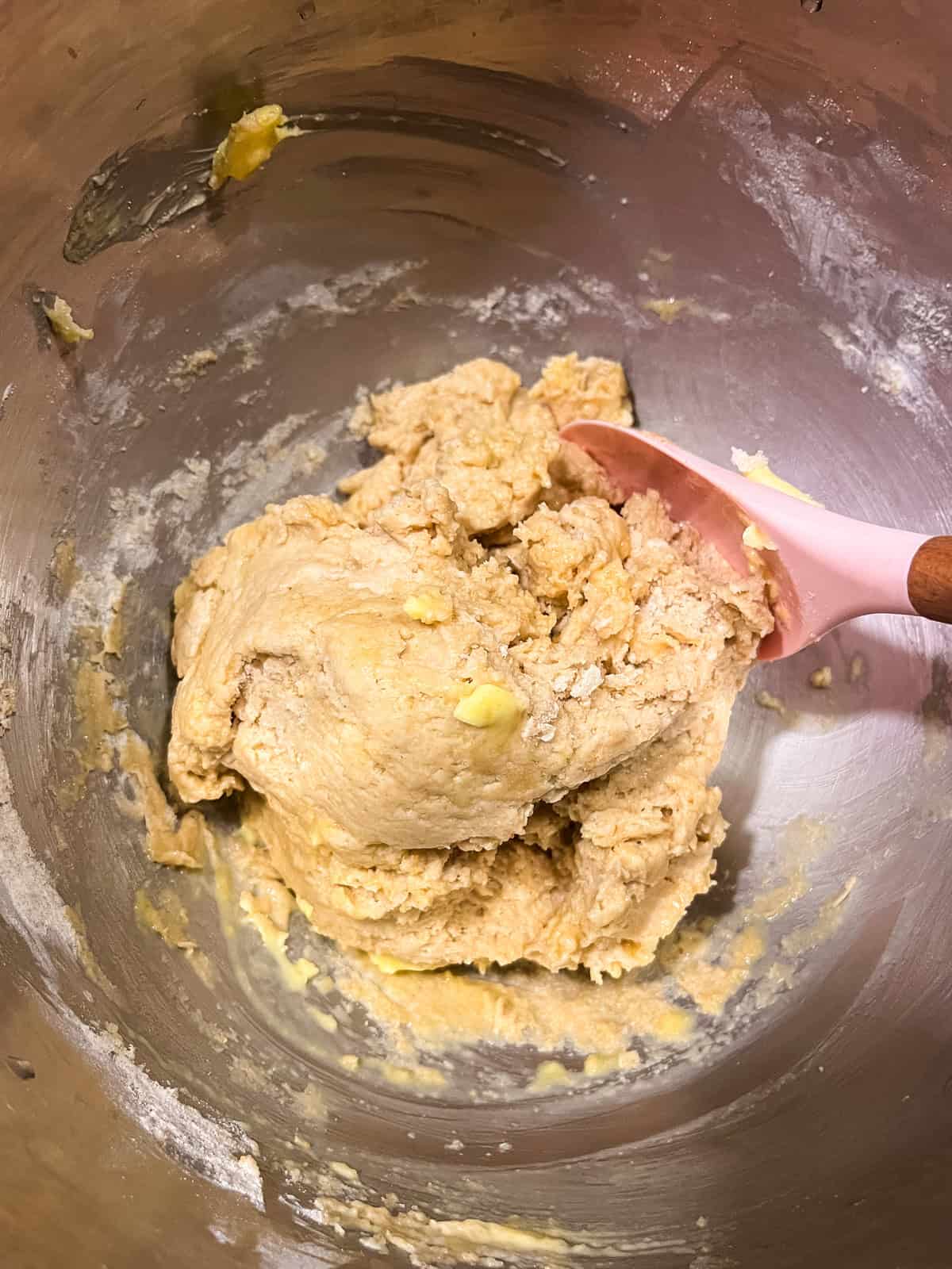 Mixing the ingredients for the whole grain bread with a rubber spatula. 