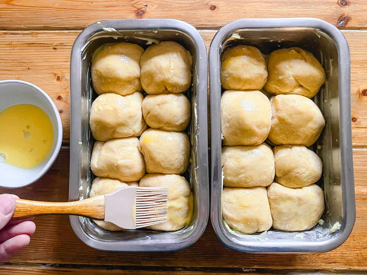 Brushing brioche bread with an egg wash.