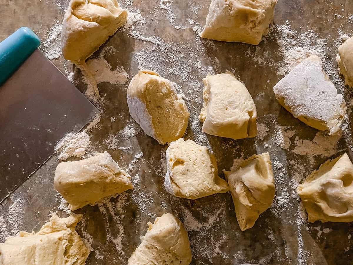 Brioche dough cut into pieces.