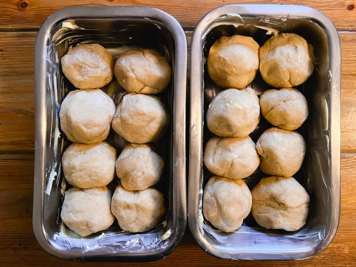 Brioche dough balls into bread pans, unbaked.