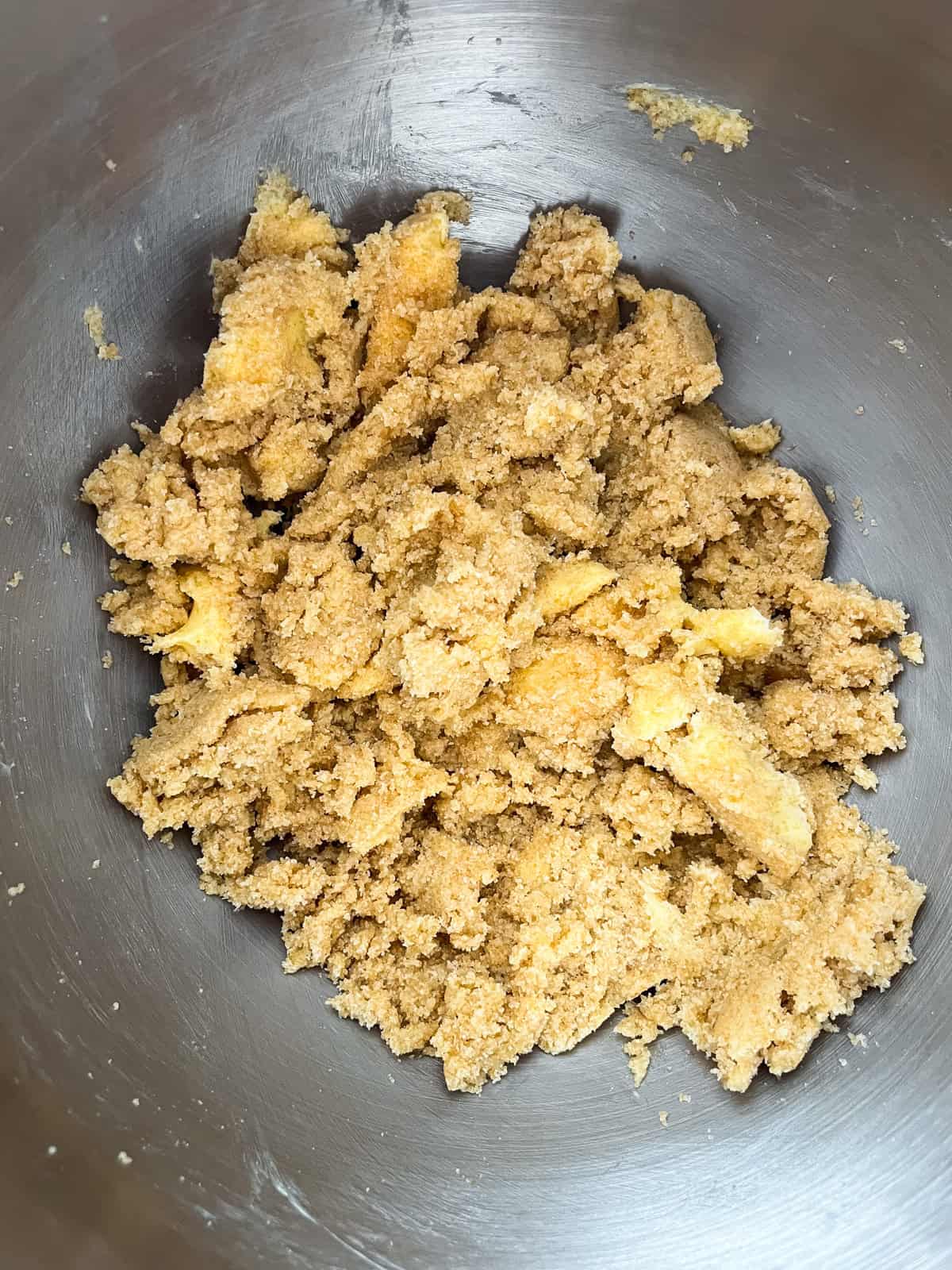 Butter and sugar creamed in a metal bowl.