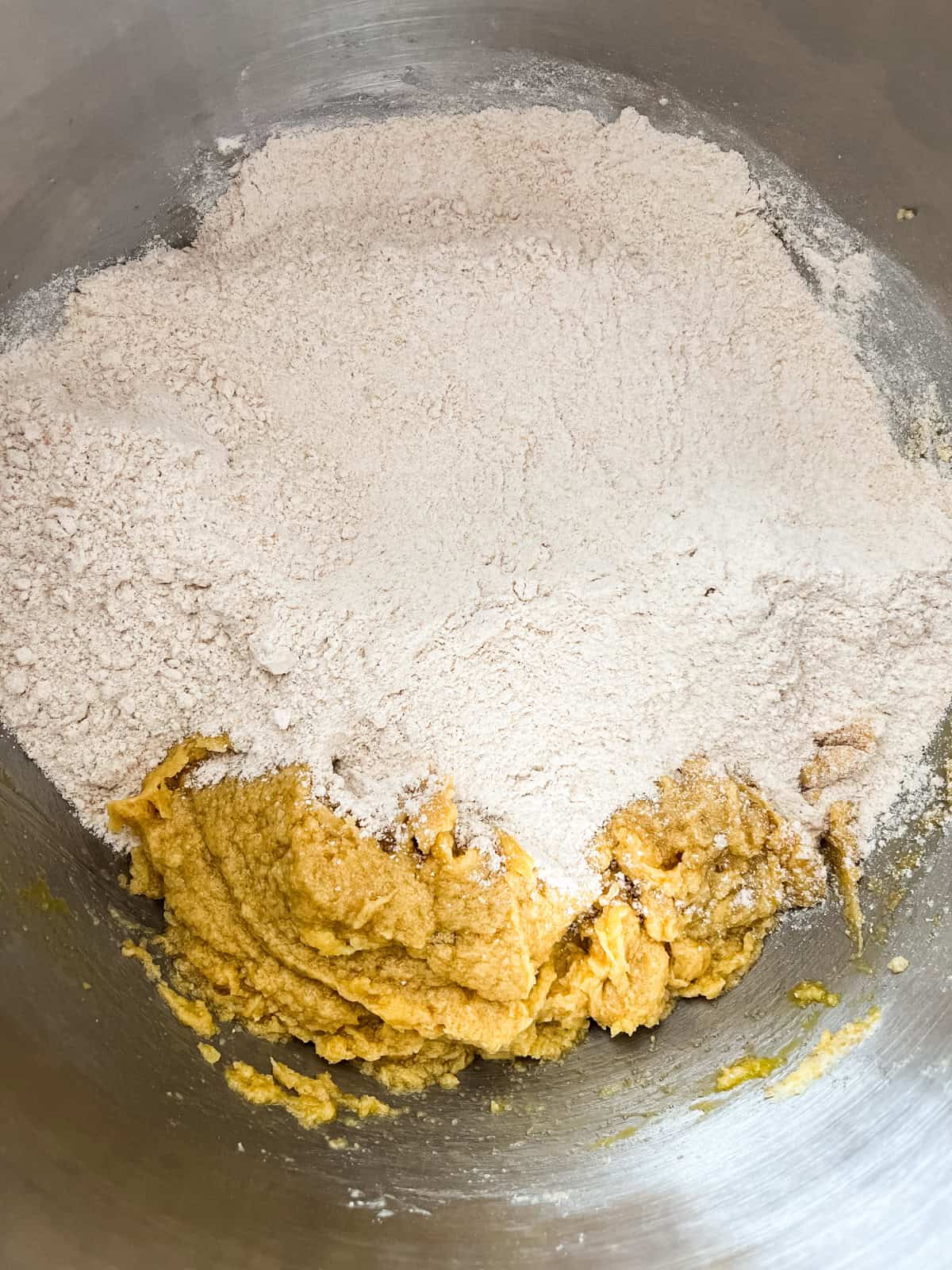 Dry ingredients added to wet ingredients in a mixing bowl.