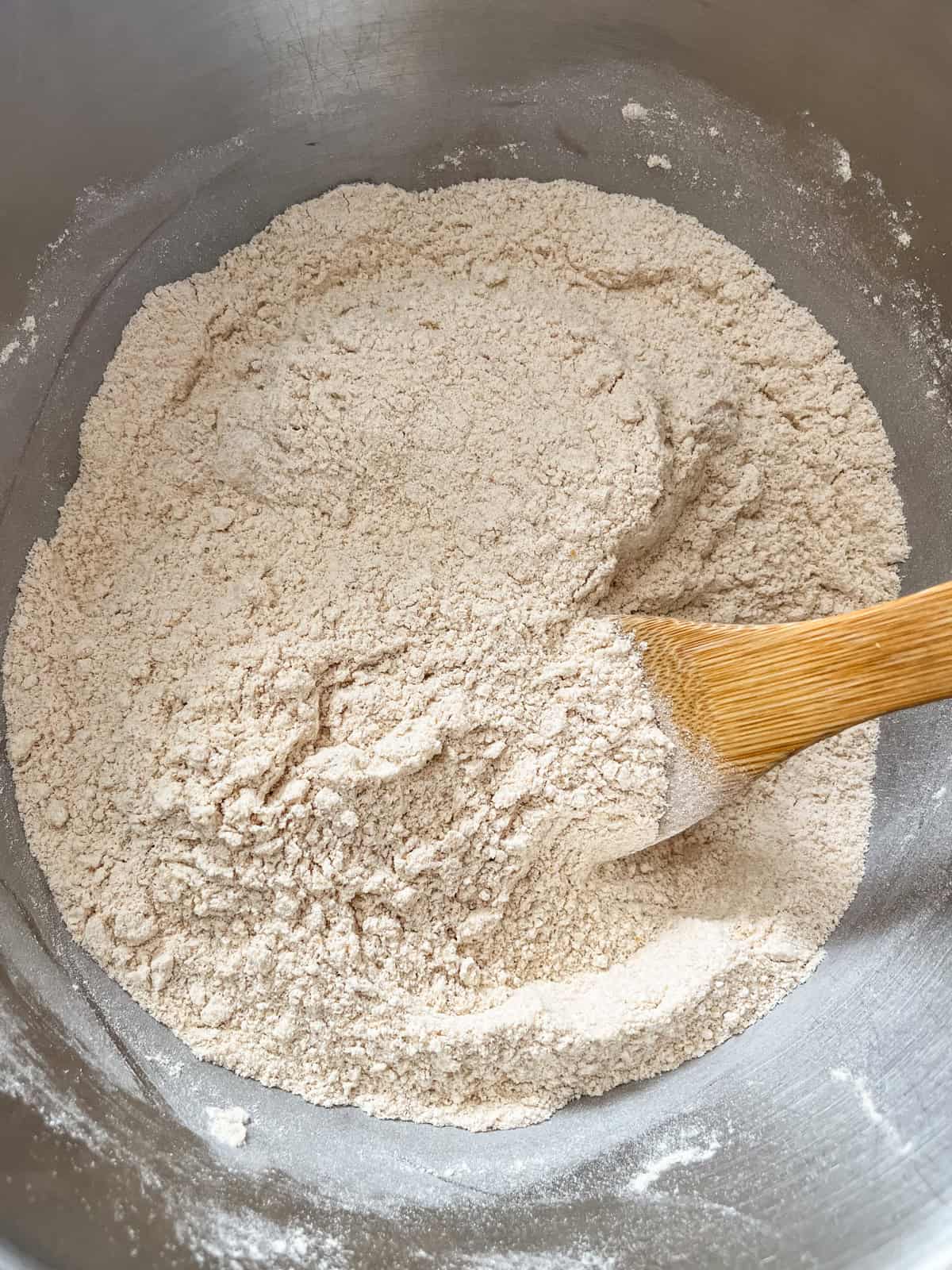 Stirring together dry ingredients with a wooden spoon.