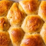 Whole grain rolls cooling in a staub baking dish.