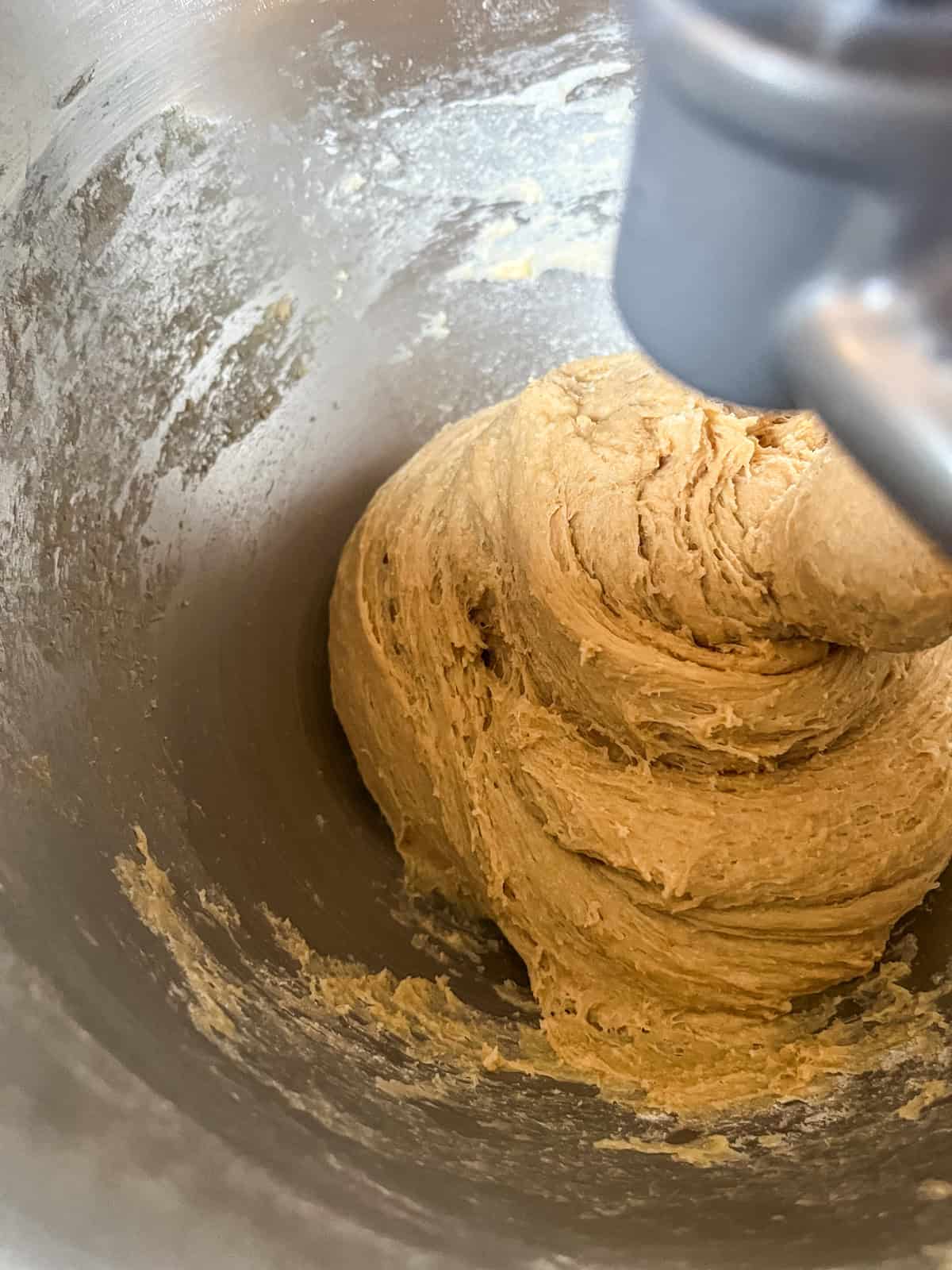 The dough finished kneading and its pulling away from the sides. Its also smooth and elastic. 