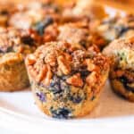 Whole grain blueberry muffins in a white plate.