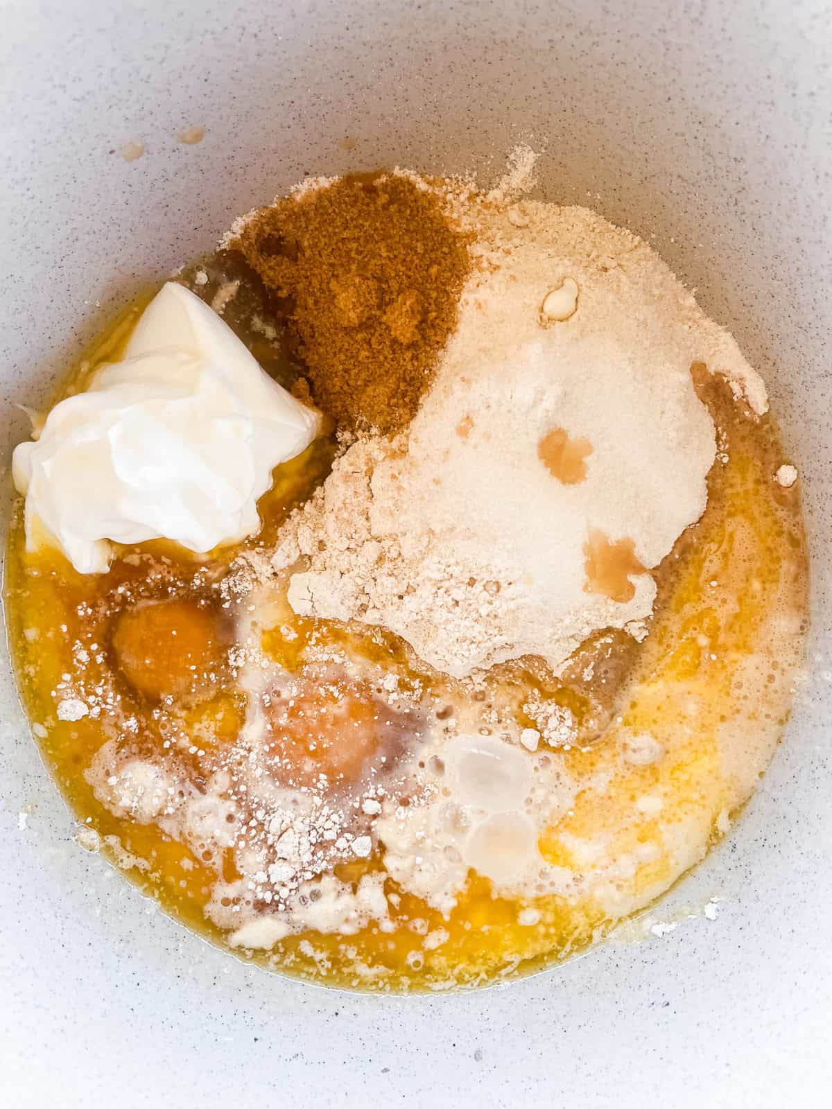Blueberry muffin ingredients in a mixing bowl.