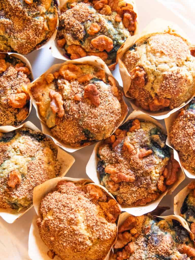 Whole grain blueberry muffins on a white plate.