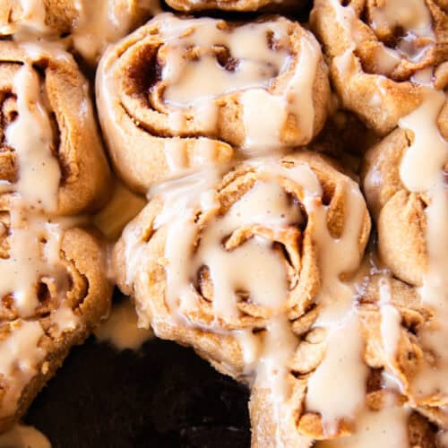 Whole grain cinnamon rolls drizzled with frosting.