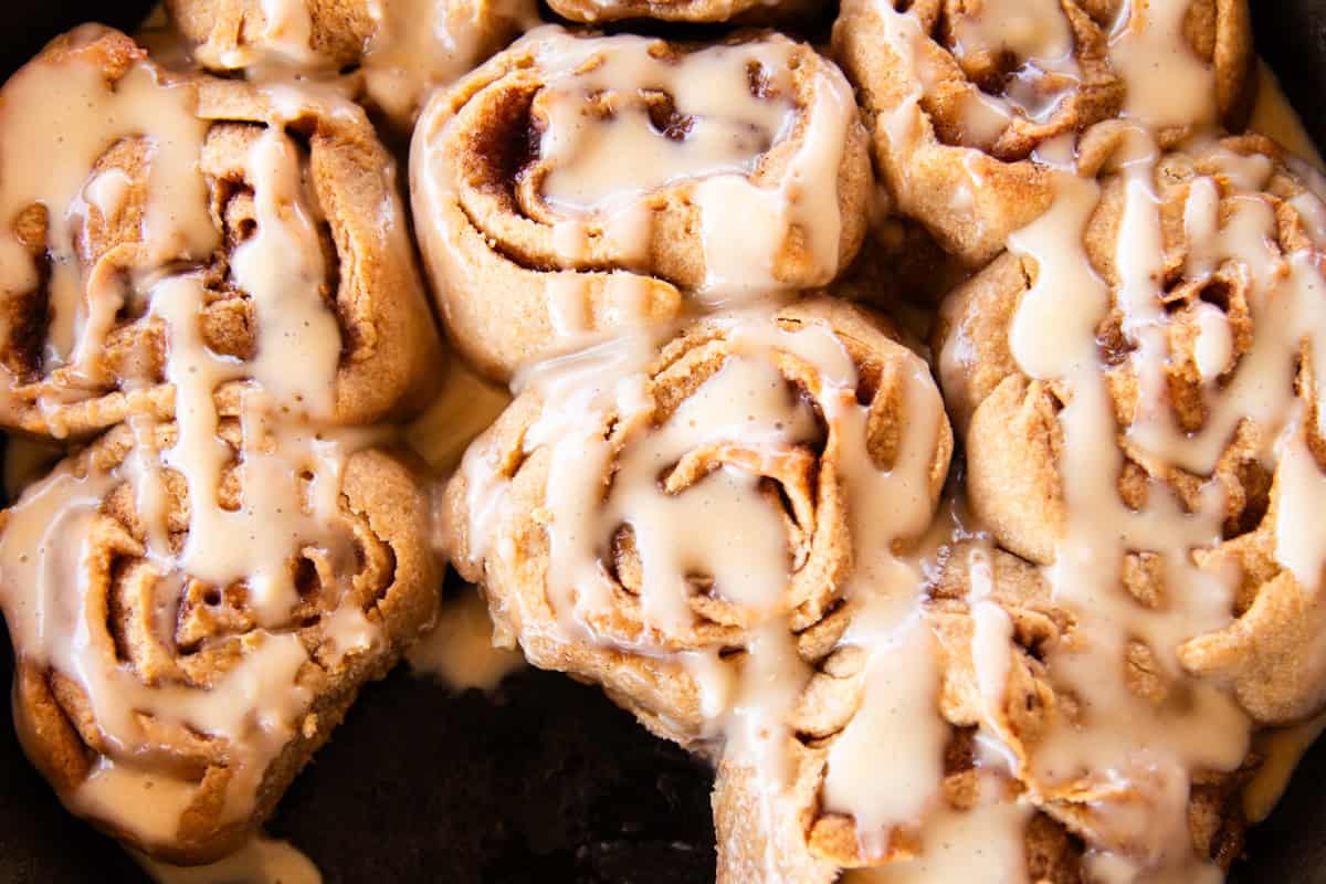 Whole grain cinnamon rolls drizzled with frosting.