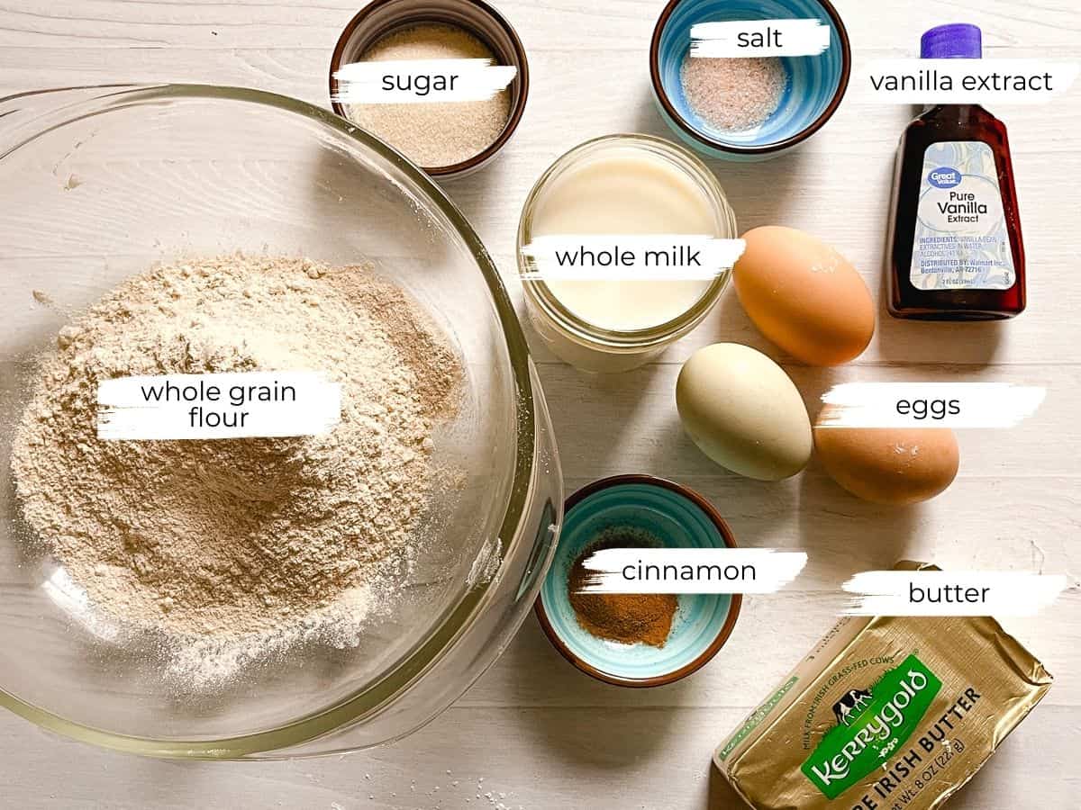Whole grain puff pancakes ingredients assembled on a white table.
