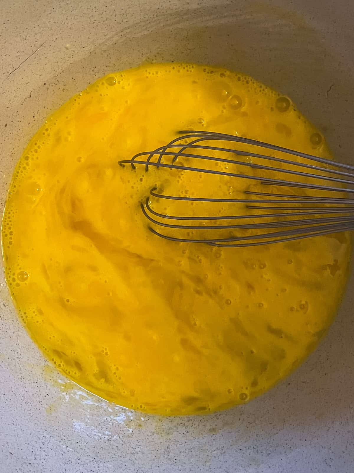 Whisking eggs in a mixing bowl.