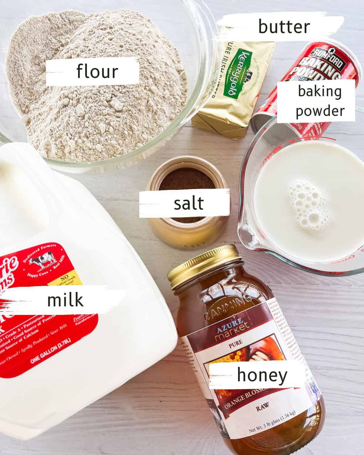 Individually portioned ingredients for Cast Iron Biscuits on a white table, with text labels overlaid.
