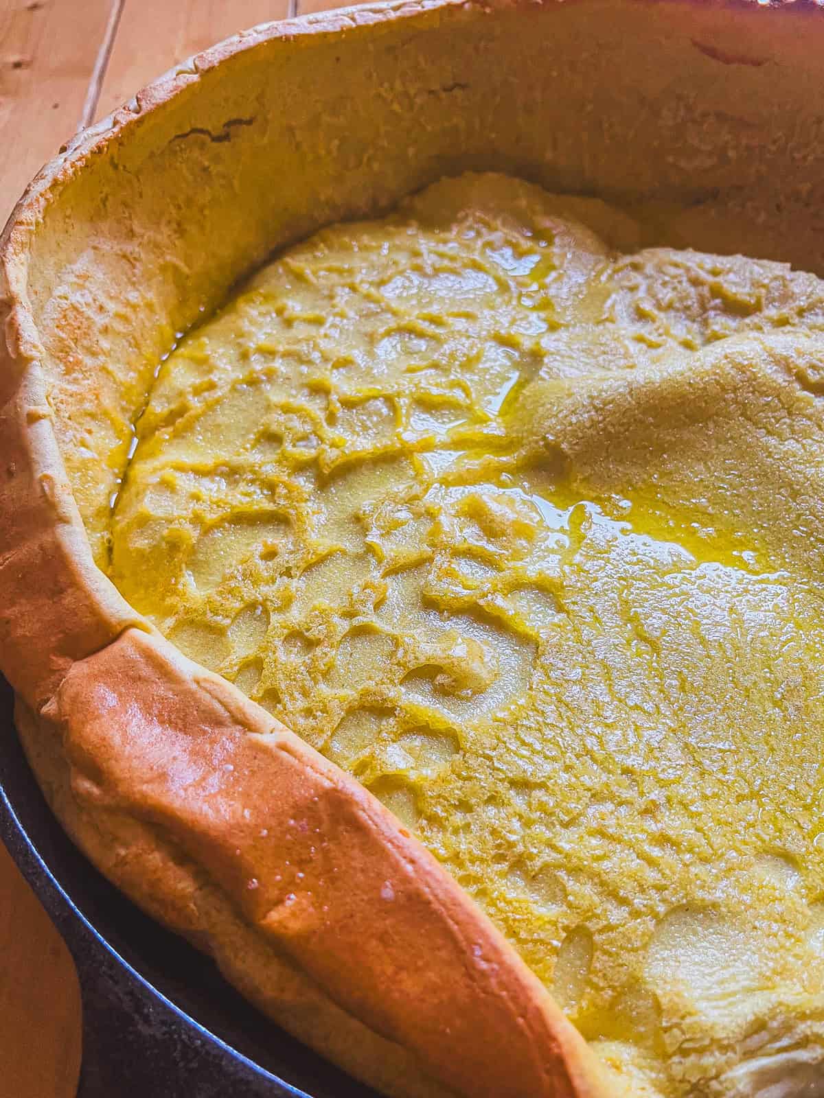 A whole grain puff pancake in a cast iron skillet.