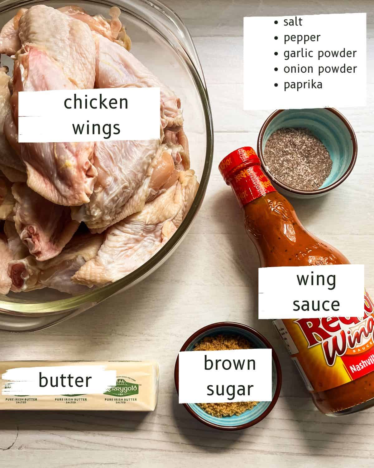 Crispy baked chicken wings ingredients labeled on a white countertop.